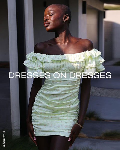 SouKeyna Diouf wearing a sage floral print off the shoulder mini dress with ruffle sleeves. Dresses on Dresses. Shop the Edit.